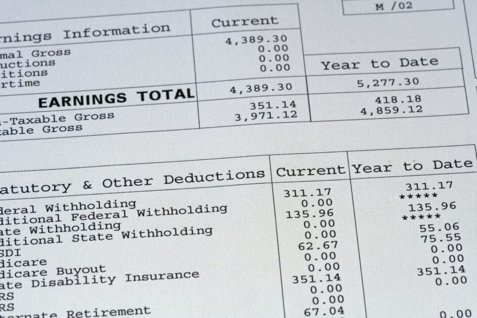 An attorney examines pay stubs as critical evidence in a workplace legal dispute.